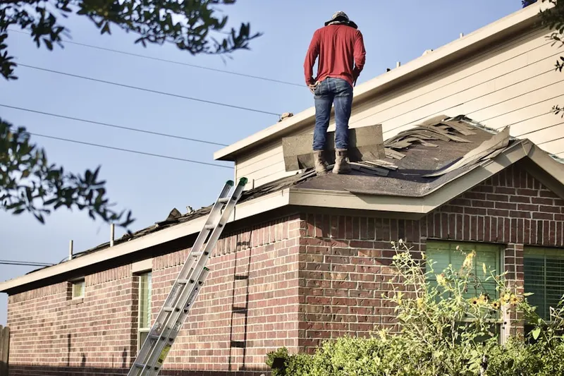 Professional roofer working on a residential roof in Fort Thomas Central Business District